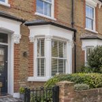 A UK rental property with a To Let board, illustrating how landlords can sell a tenanted property at auction