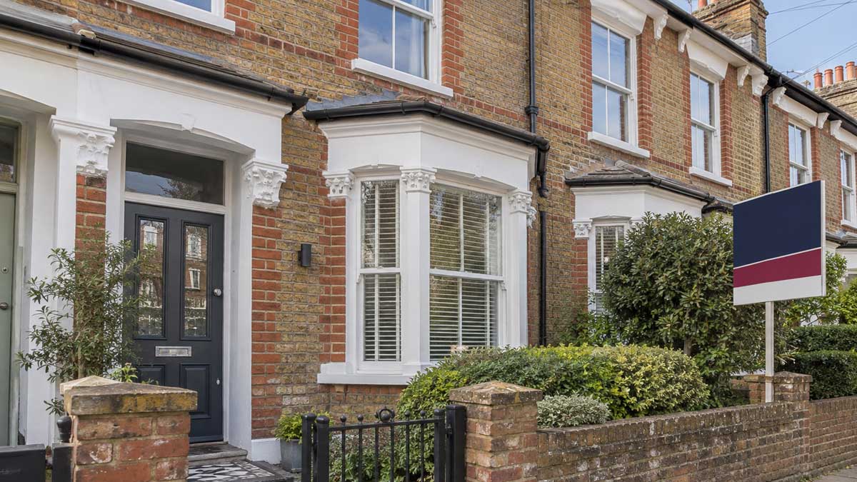 A UK rental property with a To Let board, illustrating how landlords can sell a tenanted property at auction